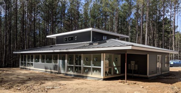 Side view of sustainable home design with landscaping