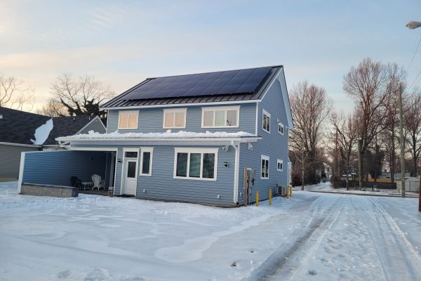 Outdoor living space adjacent to custom home with seating area