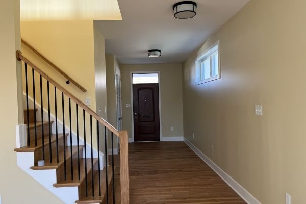 Front view of custom home facade with large windows and entry